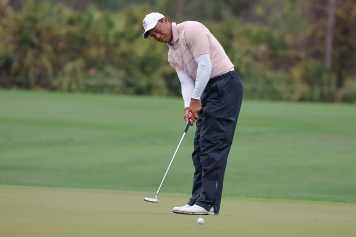 Tiger Woods putts on the fifth green during the PNC Championship.